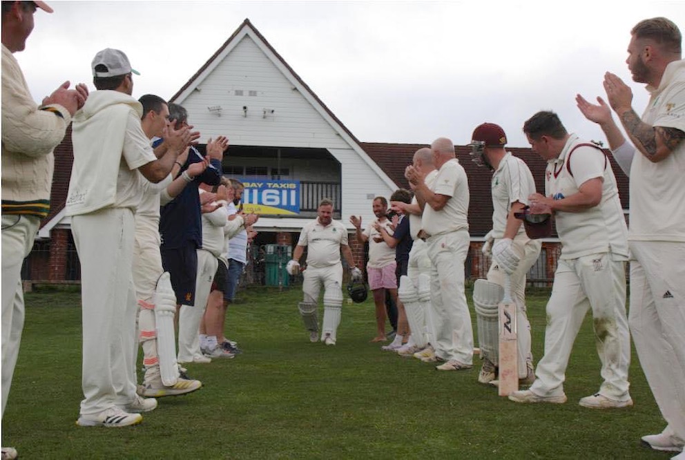 Players from both sides form a guard of honour for Adam Parker as he goes out to bat in the annual 'Legends' old boys game