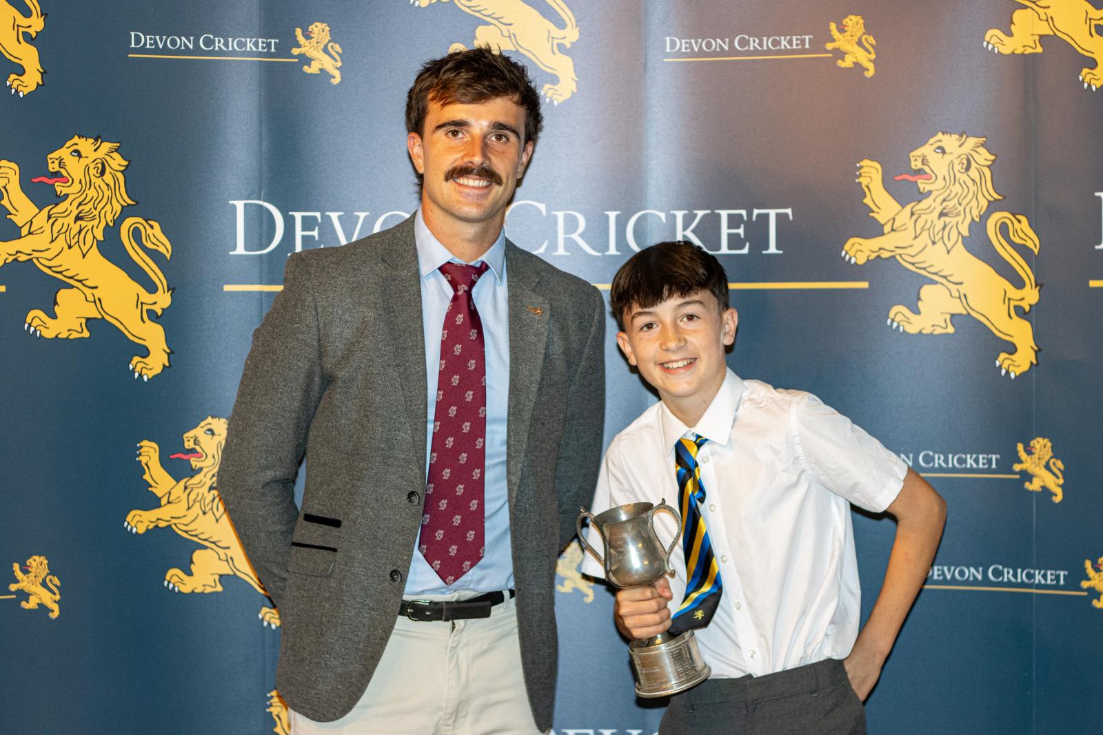 Charlie Carwardine is presented with the Under 12 Boys Player of the Year award by Ben Green.