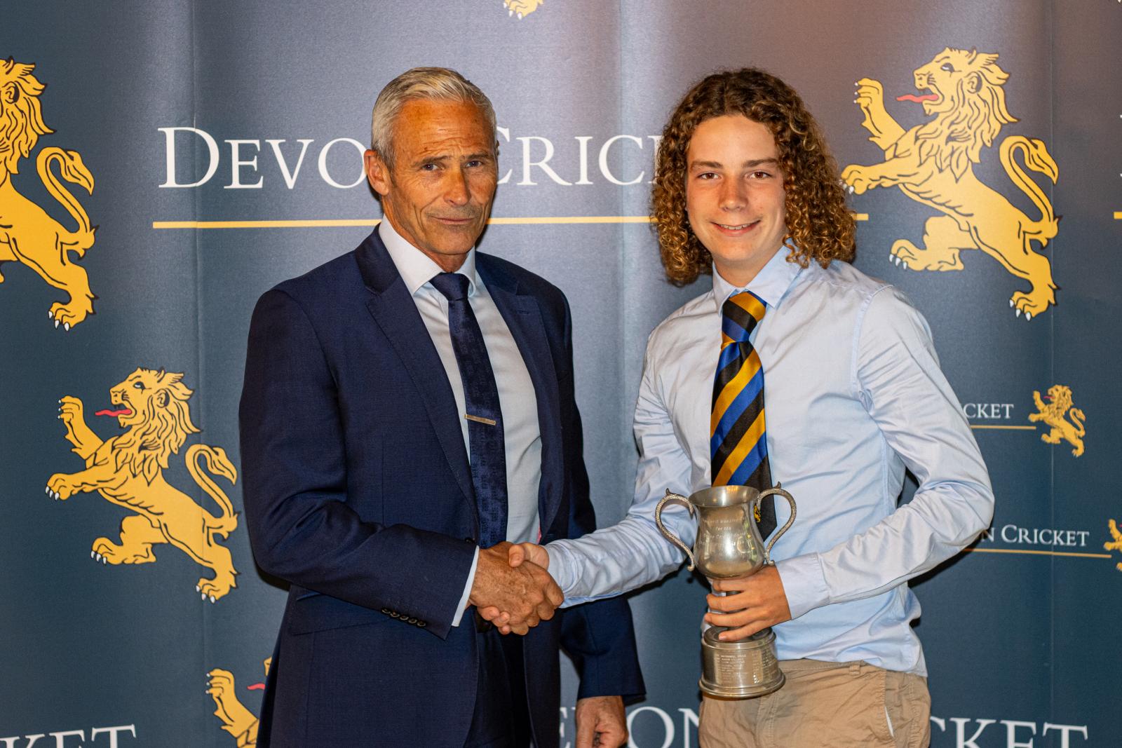 Elijah Pyne is presented with the Under 15 Boys Player of the Year award by Andy Hurry.