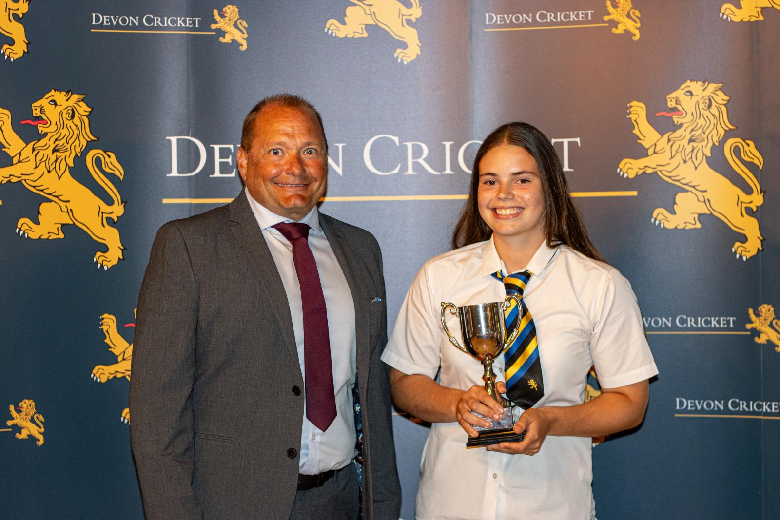 Ella Gill is presented with the Under 15 Girls Player of the Year award by Trevor Griffin.
