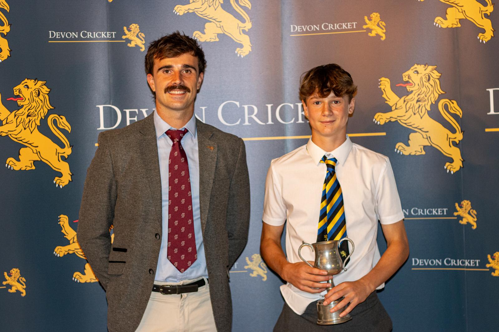 Josh Paget is presented with the Under 14 Boys Player of the Year award by Ben Green.