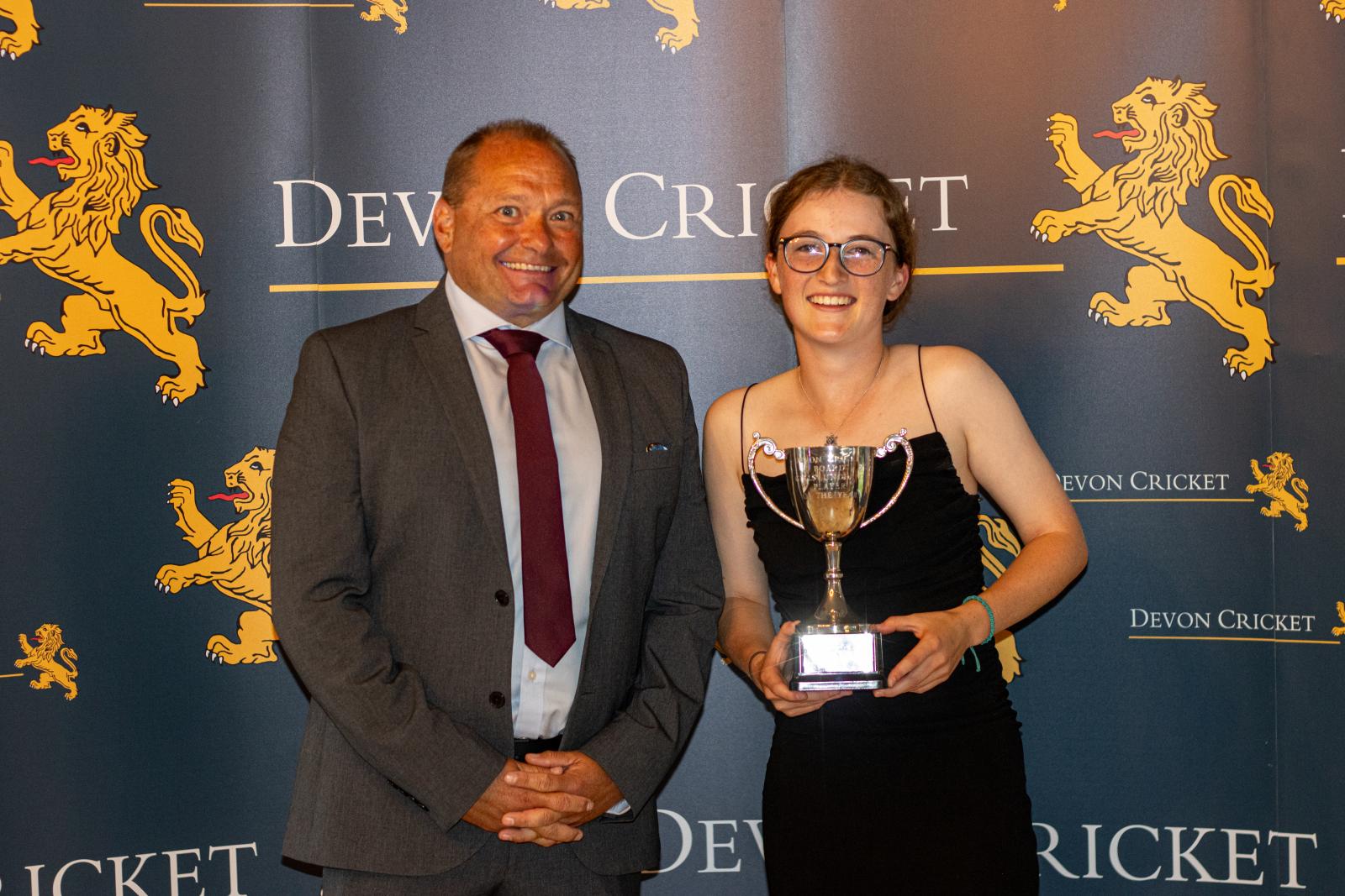 Ruby Davis is presented with the Under 18 Girls Player of the Year award by Trevor Griffin.