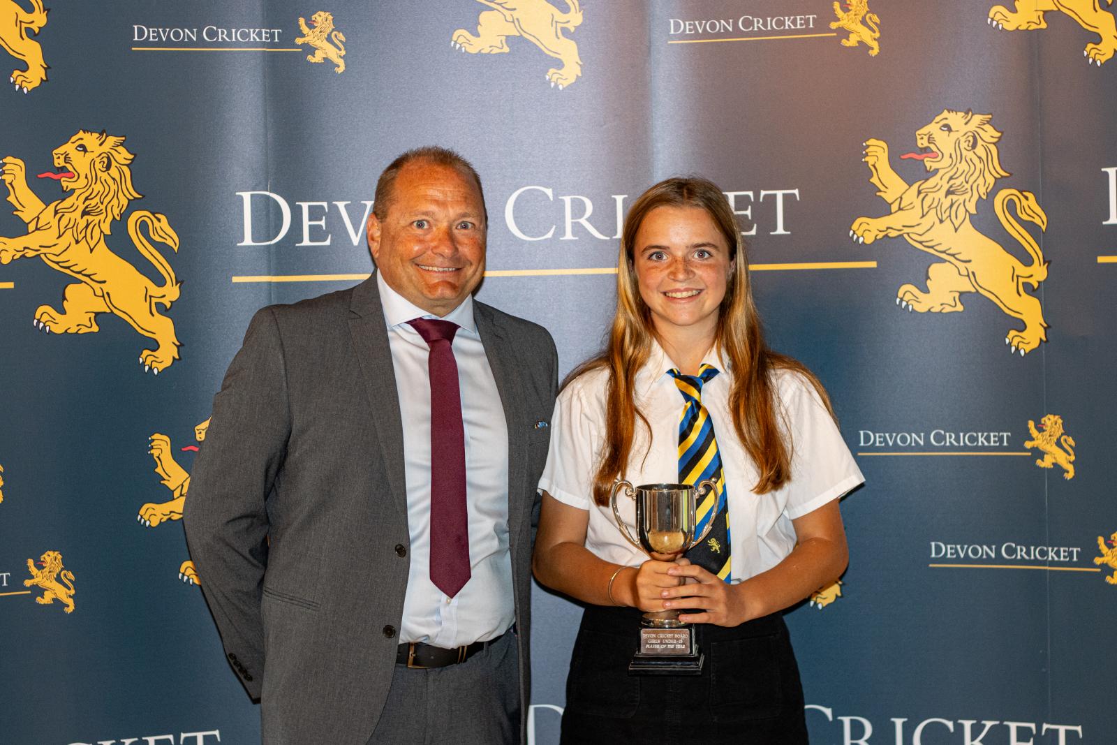 Thea Rochester is presented with the Under 13 Girls Player of the Year award by Trevor Griffin.