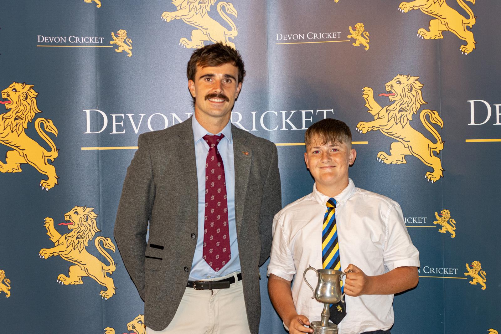 Warrick Green is presented with the Under 13 Boys Player of the Year award by Ben Green.