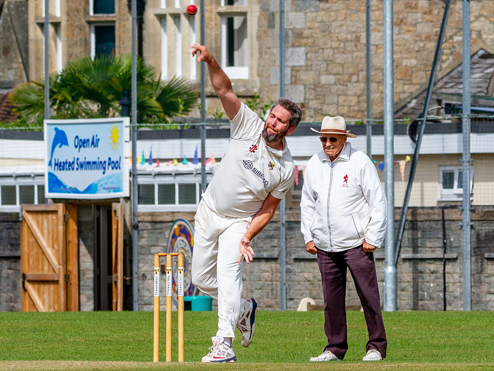 Umpire Roger Tolchard standing in a game at Bovey Tracey last season. The bowler is Chris Bradley<br>credit: Mark Lockett