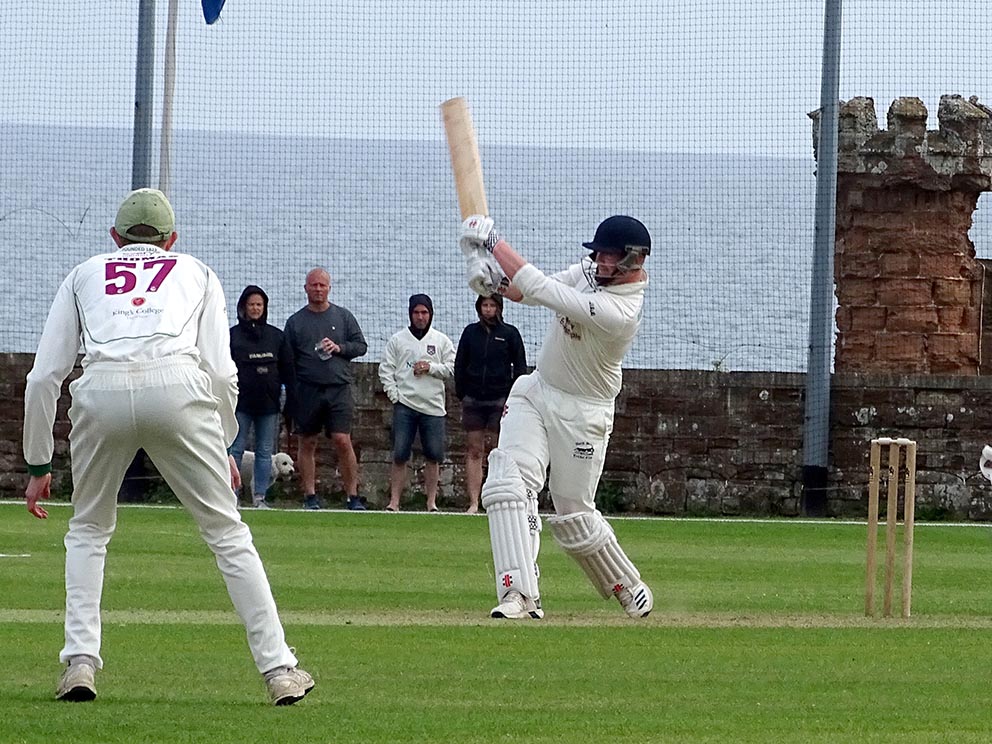 Josh Atkinson assaulting the Sidmouth bowling to put North Devon on course for victory