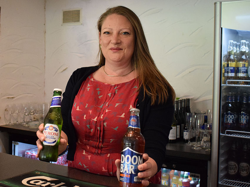 Opening time behind the bar â€“ Dawn Green with refreshments at the ready