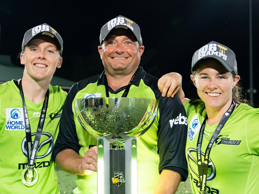 Trevor Griffin flanked by England captain Heather Knight (left) and Tammy Beaumont after the Thunder's win over Melbourne in the Big Bash grand final<br>credit: Contributed