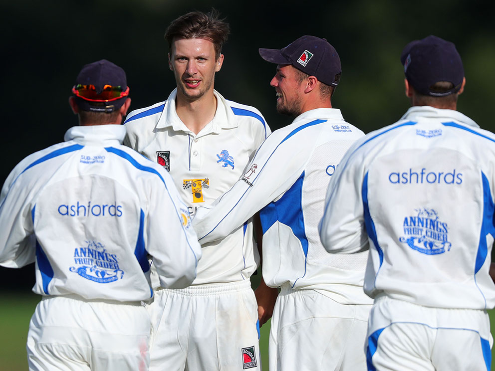 Devon's Hugo Whitlock is the centre of attention after taking a wicket in game against Wiltshire at Sandford in 2019<br>credit: www.ppauk.com 