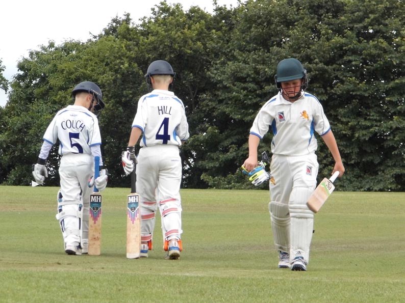 Morgan Couch (5) and Fin Hall (4) talk tactics as opener Julian Hayter makes his way off