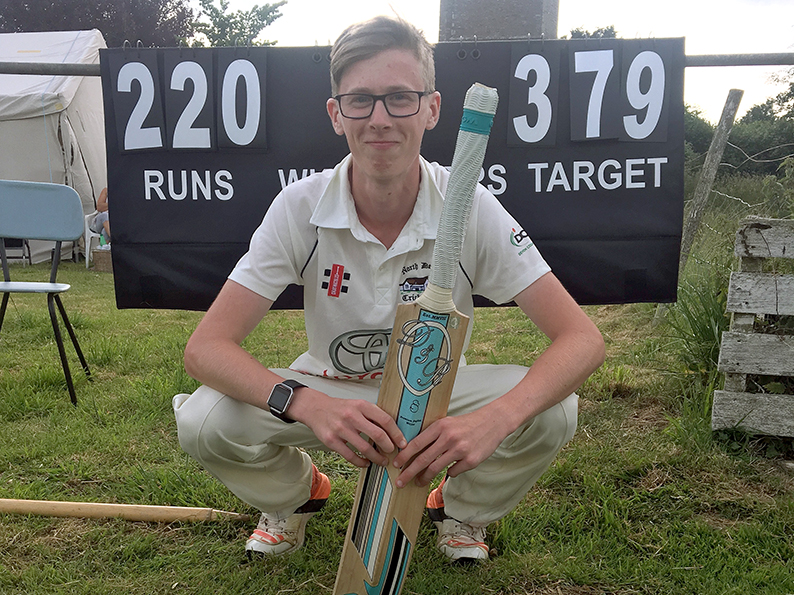 Double Ton Clubber - North Devon's Jay Rothery in front of the scoreboard showing his exploits