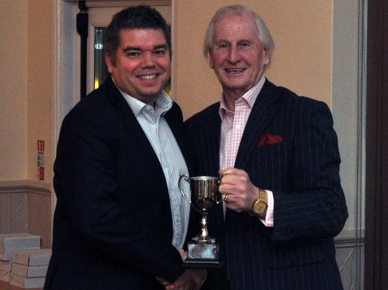 Stuart Munday (left) presenting the 2015 Premier Division trophy to Torquay's Tim Western