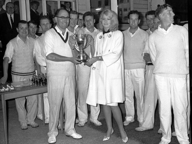 Vic Stoneman, captain of the 1963 winners Babbacombe, receiving the trophy from Roxanne Narracott