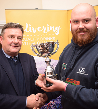 Jim Mardell of Tolchards presents Chelston & Kingskerswell captain Chris Stubbs with the E Division West champions cup