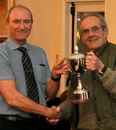 League president Graham Shears (right) hands the services to cricket award to Phil Bees