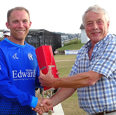 Heathcoat's Rob Holman (left) receiving his man-of-the-match award from league chairman Nick Rogers following the 2019 Devon KO Cup final