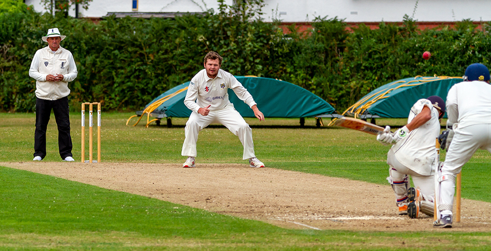 Bovey Tracey captain Toby Codd on his way to a four-wicket haul against Exeter | Photo: Mark Lockett 