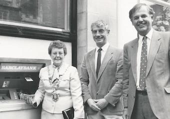 Bryan Lang (far right) outside Barclays Bank in Totnes for the official opening of a new cash machine at the branch, which is now a coffee shop