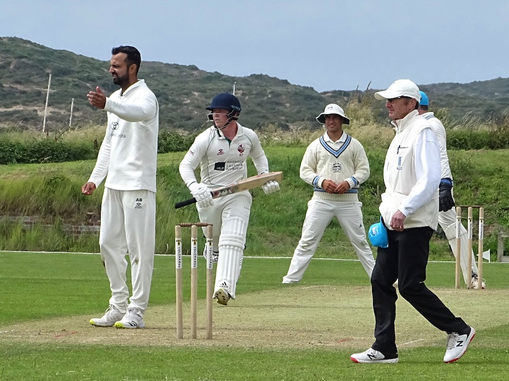 MCC batsman Jamie Baird comes back for a second run as North Devon bowler Abhishek Batra urges the fielder to get the ball back to him