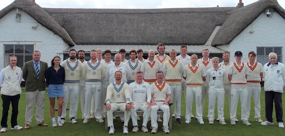 North Devon on the left and MCC (right) pose in front of the Instow pavilion prior to the match