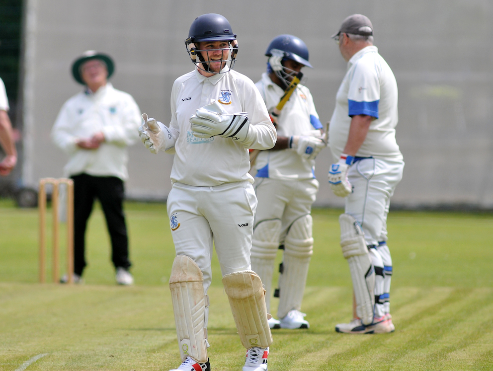 Brixham keeper Dalton Sanders between overs during the game at South Devon | Photo: Steve Pope/MDA