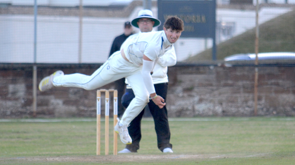 Devon's Ben Privett slings down a delivery in the gathering gloom at Sidmouth