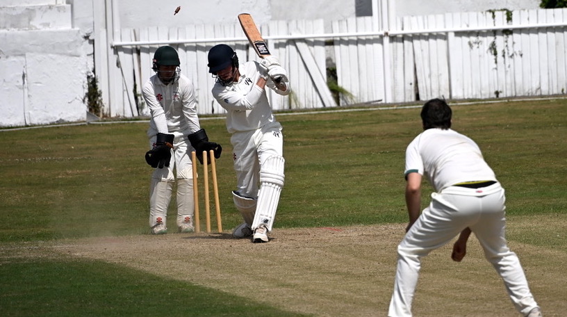 That's out! The bails fly and Heathcoat batsman Will Edwards is on his way back to the Hatherleigh pavilion 