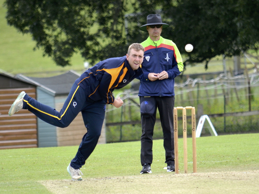Umpire Steve Lavis looks on impassively as Sam Read bowls against Dorset