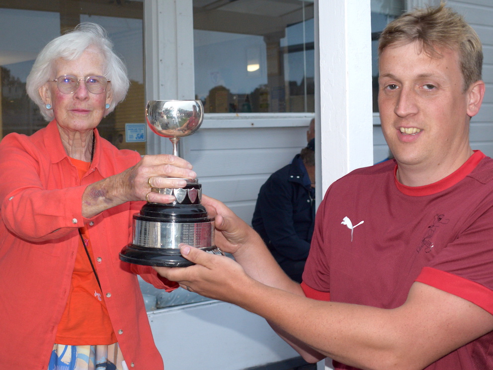Angela Glendenning hands the Brockman Cup donated by her grandfather to winning captain Ash Harvey