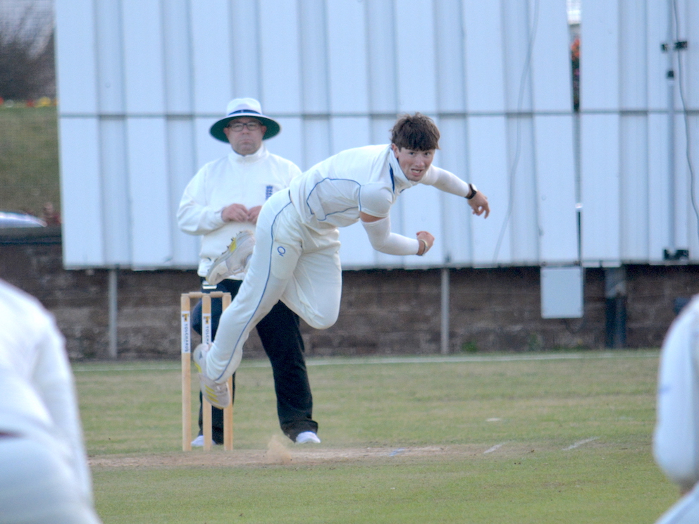 Devon's Ben Privett bowling against Oxfordshire in the gathering gloom on day one at Sidmouth