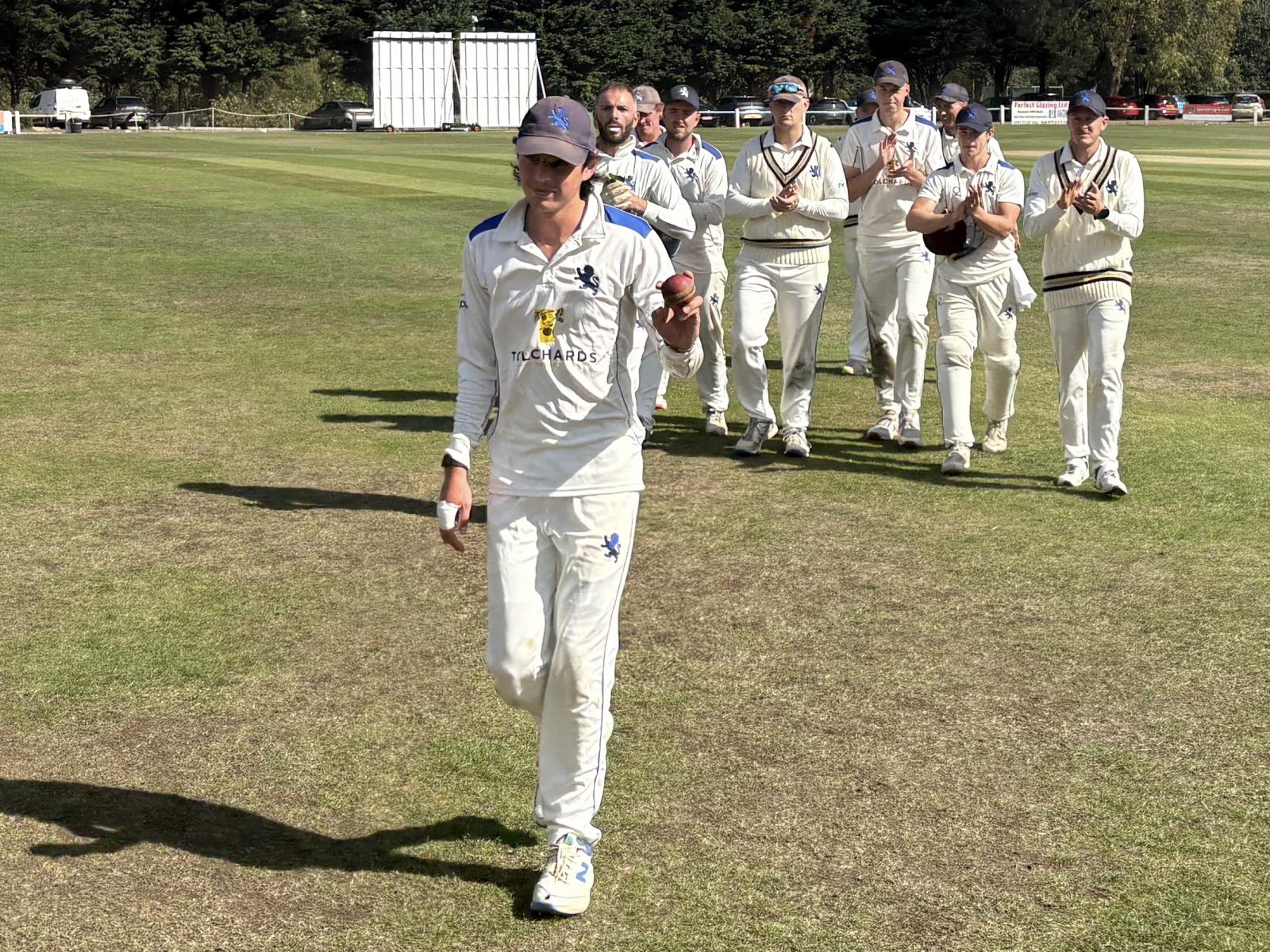 Callum Harvey leads Devon off after taking six wickets to help dismiss Bucks on day three