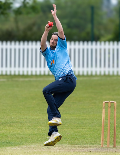 Jamie Palmer runs in to bowl