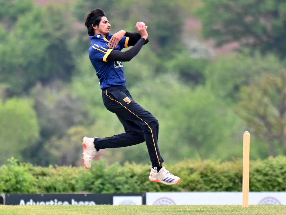 Tavistock's Pakistani paceman Ahmad Hasan leaps into his delivery stride during the game against Bradninch & Kentisbeare