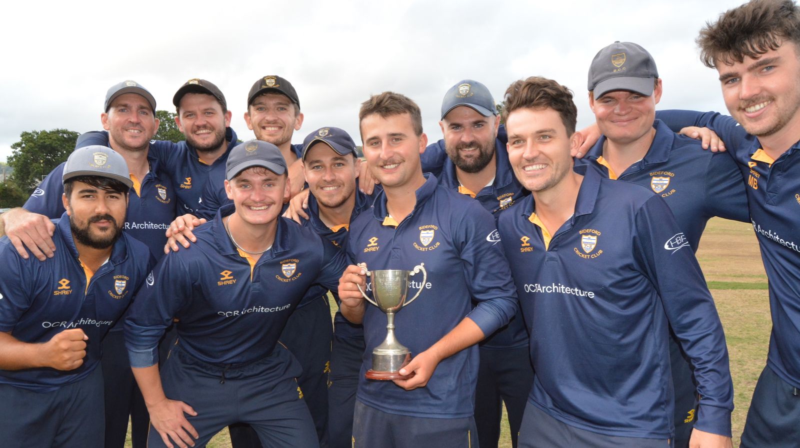 Bideford's title-winning captain Jack Ford shows off the silverware surrounded by his team<br>credit: Conrad Sutcliffe - no re-use without copyright owner's consent
