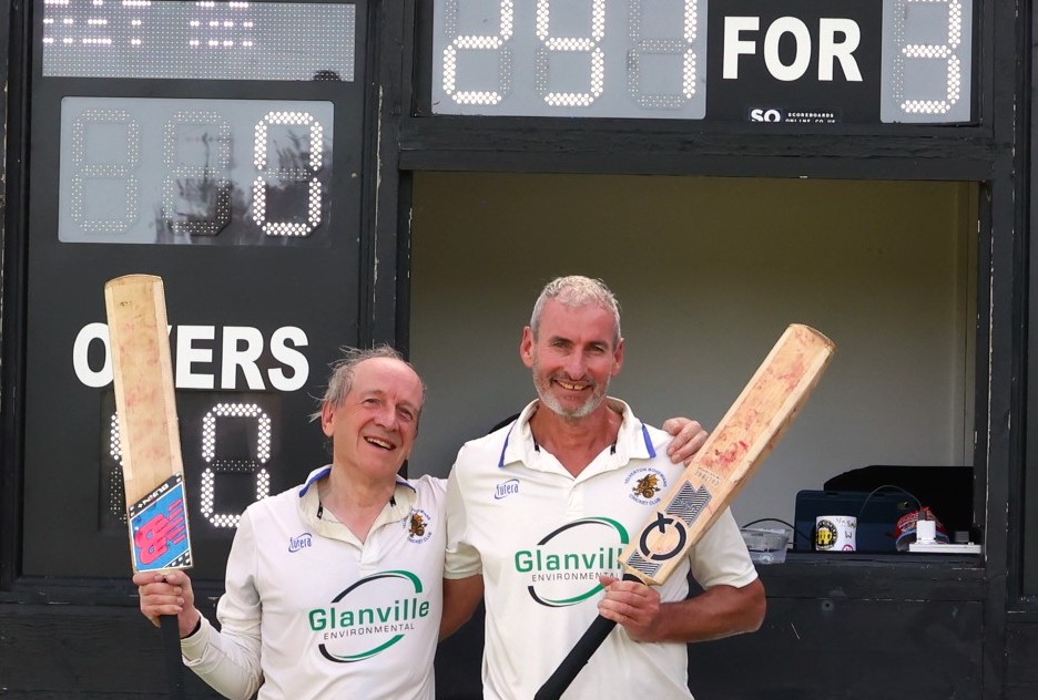 Martin Goff (left) and Lee Foskett in front of the Langton Park scoreboard with the evidence of their record breaking stand<br>credit: Chris Cottrell