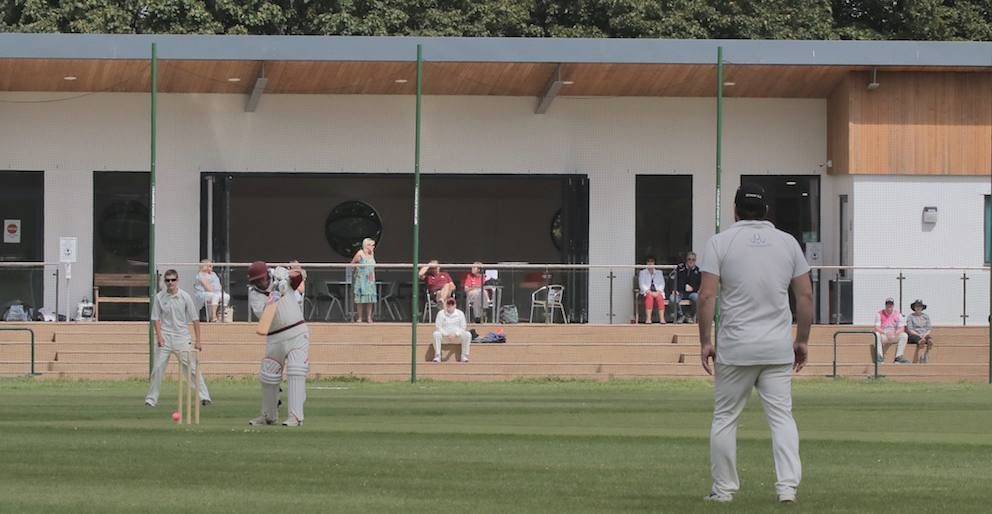 Cricket being played in front of the new pavilion at Manadon