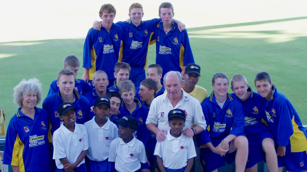 Alan Swift (front) row with the 2003 South Africa touring party handing over kit to a Township team on the boundary at Newlands cricket ground in Cape Town<br>credit: Archive 