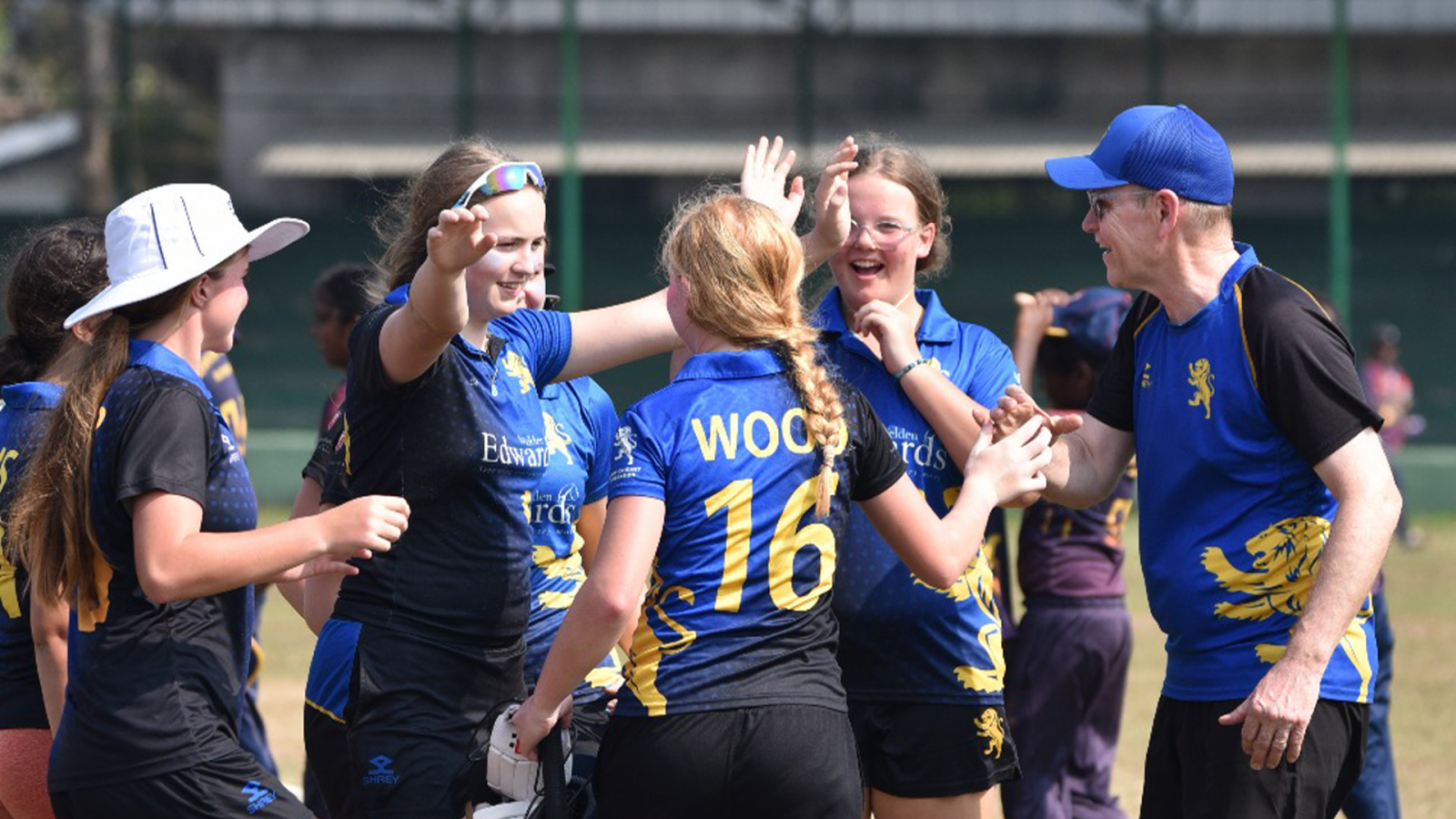 The team celebrates with Charlotte Wood after her 57* against Devapathiraja College.