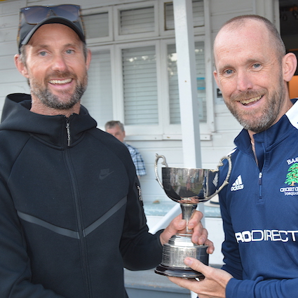Matt Needham (right) collects the Bill Stanbury Trophy from Erik Gregersen for his MoM performance in the Brockman Cup final