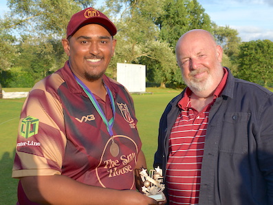 Cup final man-of-the-match Justin Pringle receiving his memento from league secretary David Sheppard